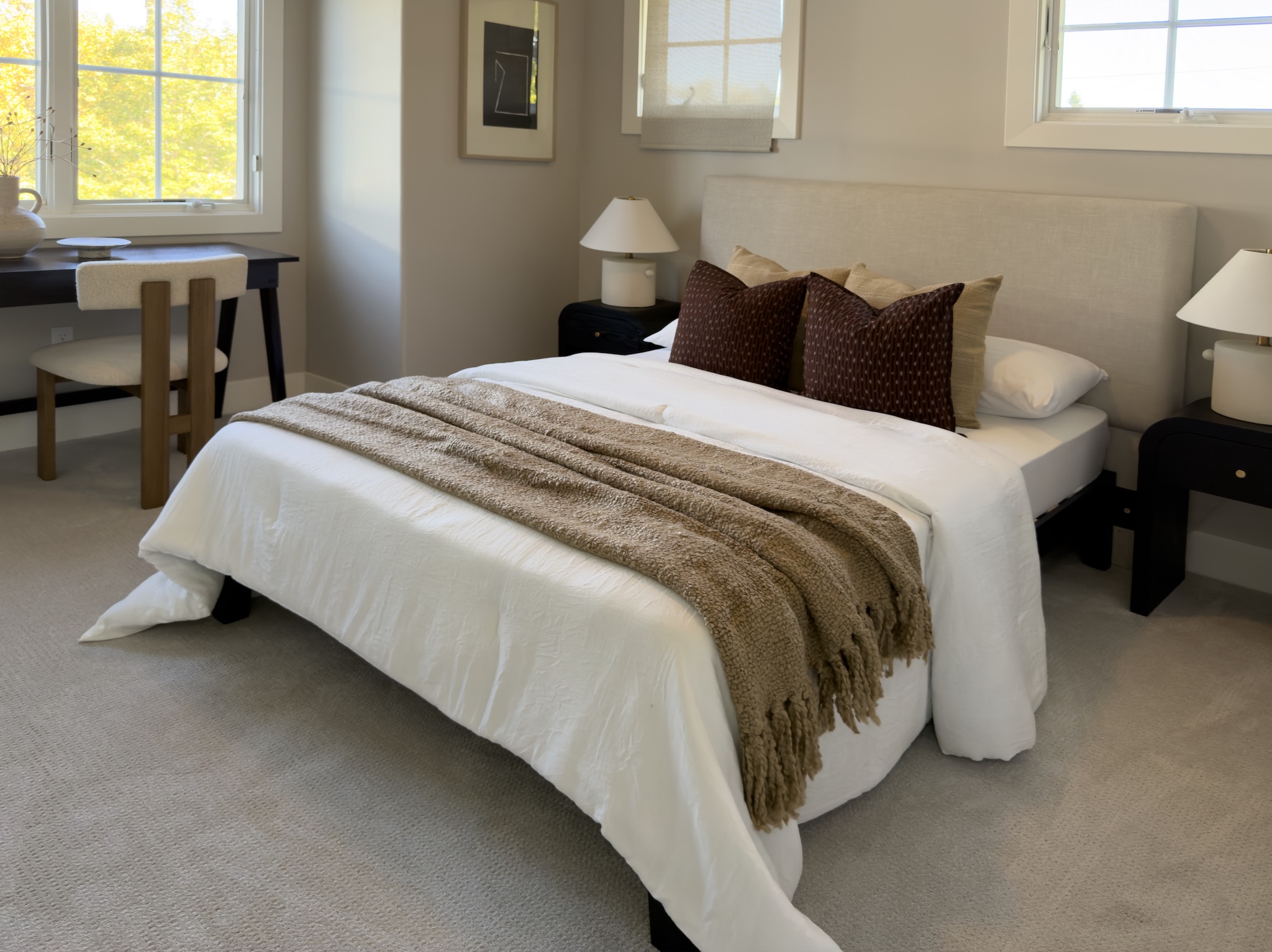 Bedroom with wood bed and knit throw