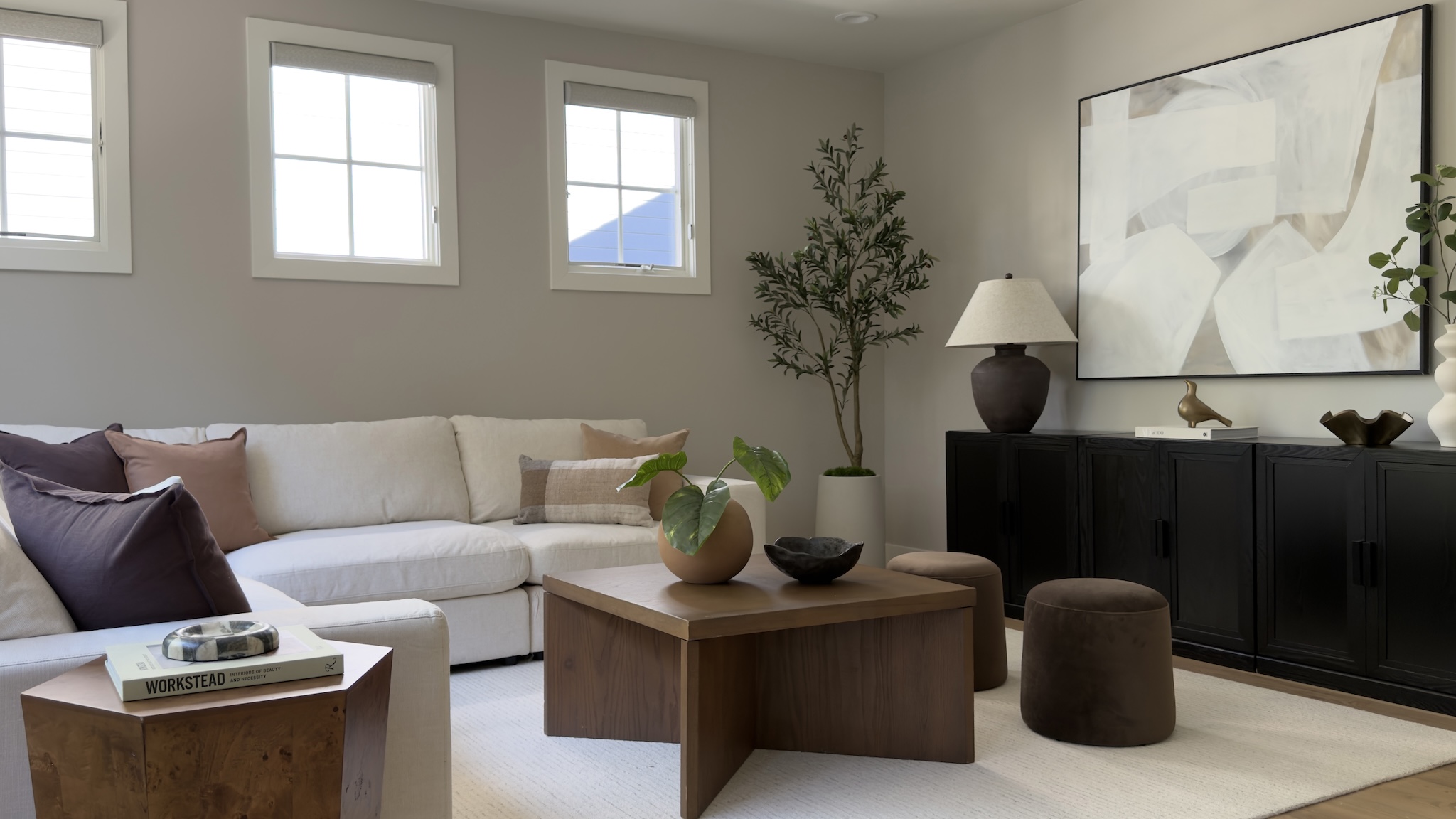 Family room with sectional, wood coffee table and black console